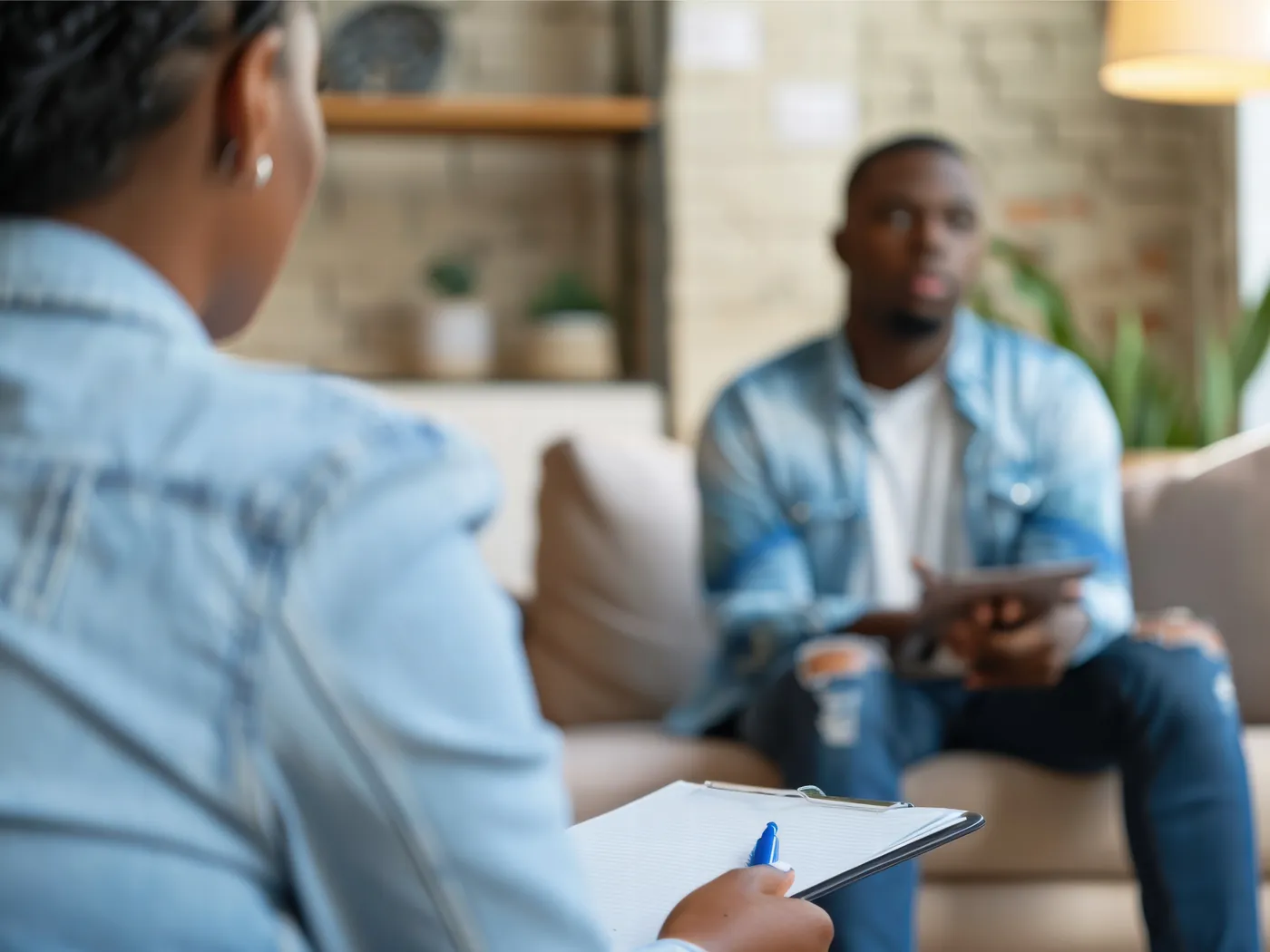A therapist listening as a client speaks during a session